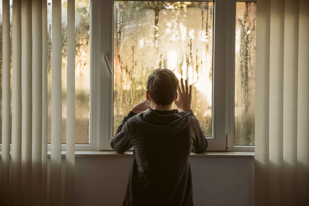 Autistic child using headphones during a thunderstorm